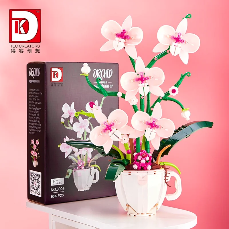 نمای مورب از لگو گل ارکیده در فنجان کنار جعبه - Orchid in Coffee Cup